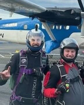 Skydivers under canopy, marking two local jumpers receiving Joel Awards at Lost Prairie